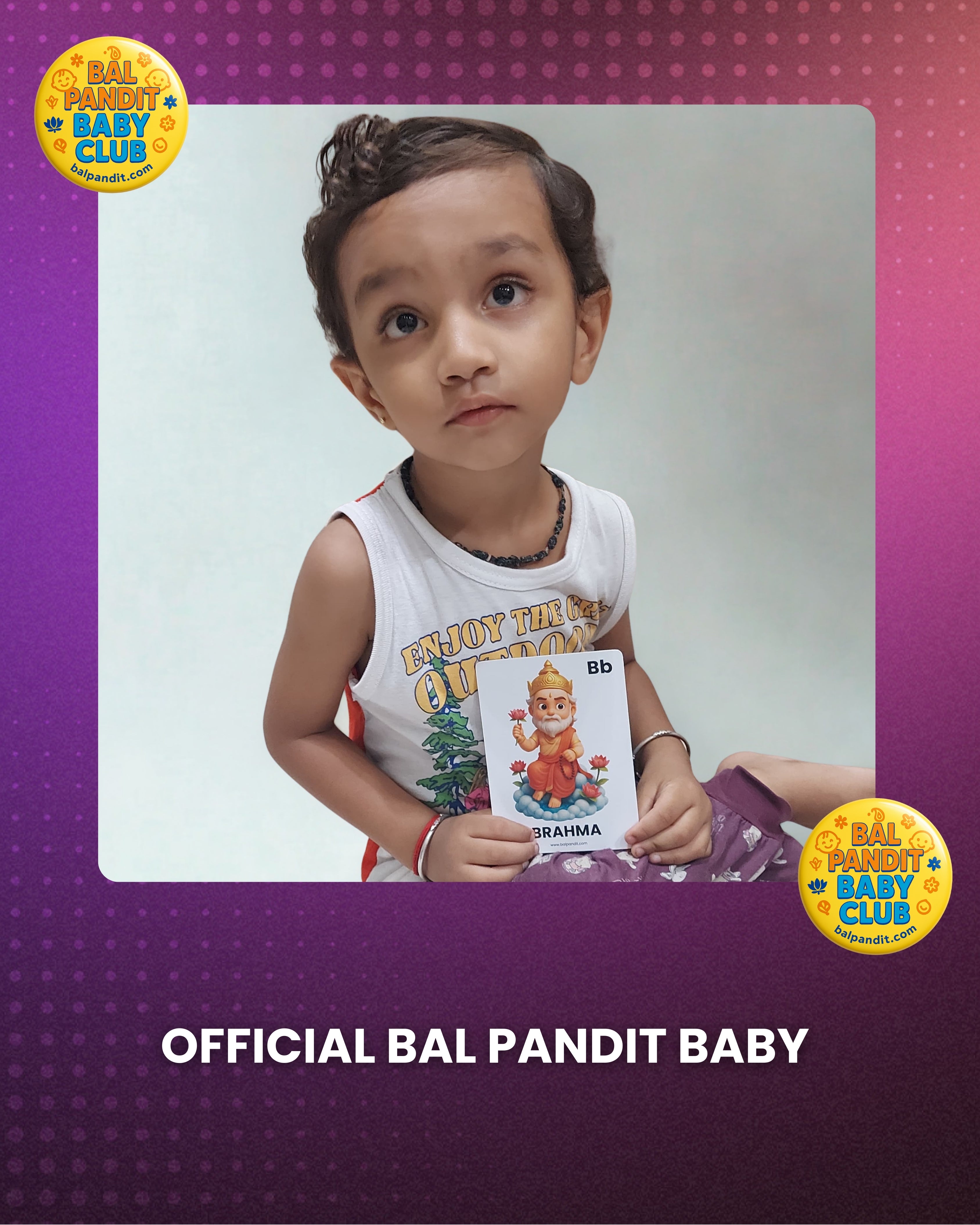 A little Bal Pandit learner exploring a Brahma alphabet flashcard